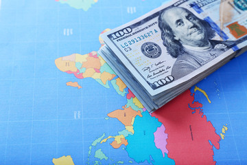 Fototapeta na wymiar Cash on the world map background, close up