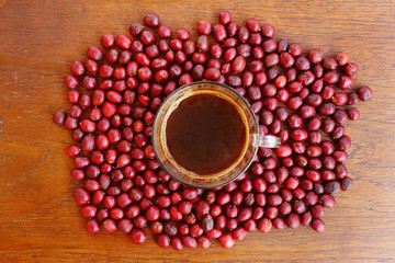 Coffee cup and fresh coffee beans on table