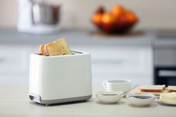 Toaster with dishes on a light kitchen table