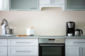 Fototapeta premium Toaster with coffee maker and mixer on a light kitchen table
