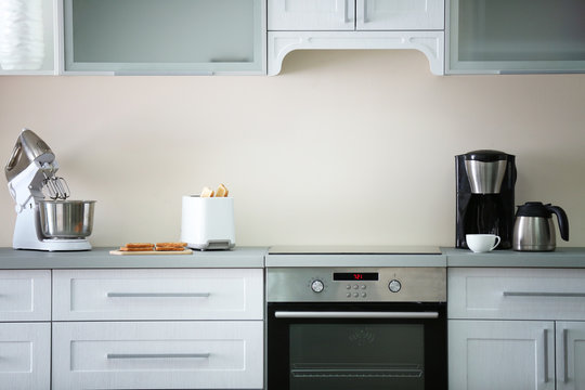 Toaster With Coffee Maker And Mixer On A Light Kitchen Table