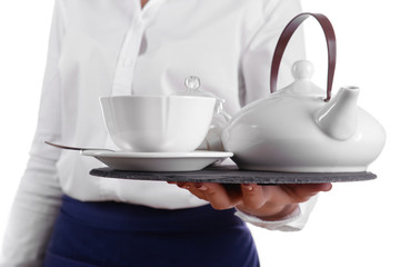Waiter holding tray with cup and teapot on white background