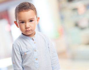 portrait of a little boy with serious gesture