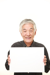 senior Japanese man with message board 