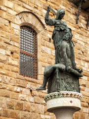 Naklejka premium Sculpture in front of the stone wall. Florence, Italy