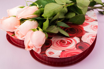 Fresh cut roses and candy box - gift for Valentines Day.