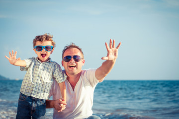 Father and son playing on the beach at the day time.