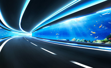 Fototapeta na wymiar Abstract blurred speed motion road in glass tunnel underwater