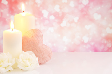 Obraz na płótnie Canvas Valentine's hearts and candles with a bright background