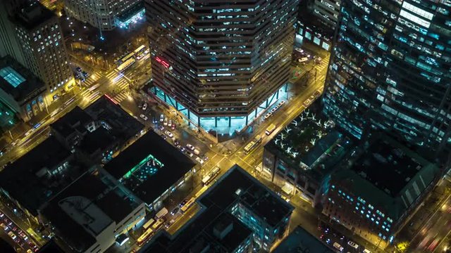 Aerial Bird's Eye view of Downtown City Streets at Night in Business District Cityscape Time-lapse