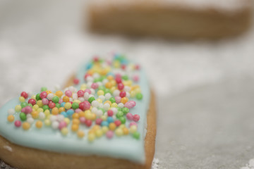 Baked valentine's heart covered with blue icing and confetti