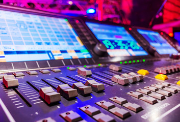 Professional audio sound mixer with buttons and sliders . Selective focus . A little of DOF.