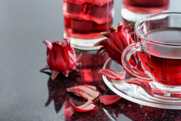 Closeup view of cup of hibiscus tea (rosella, karkade) on table