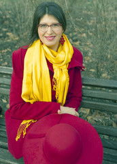 Young woman on the street at winter time. Red coat.
