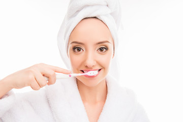 Young cute girl with towel on her head holding toothbrush