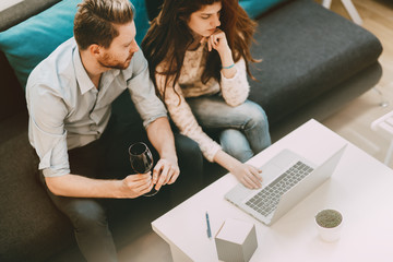 Beautiful couple working on laptop