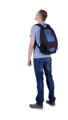 Fototapeta premium Back view of man with backpack looking up.