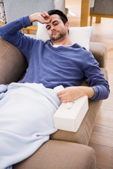 Fototapeta premium Sick man lying on the couch