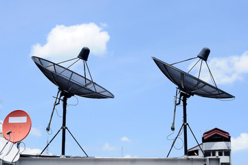 Various Satellite dishes on top of building