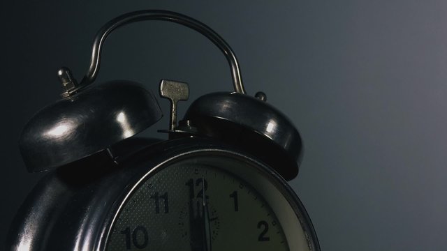 Vintage alarm clock time lapse, passing of time, clock ticking fast time accelerated.