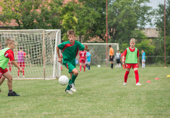 boy kicking football