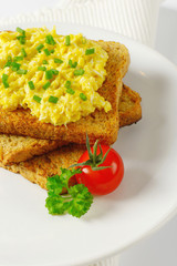 Scrambled eggs ith chopped chives on toast