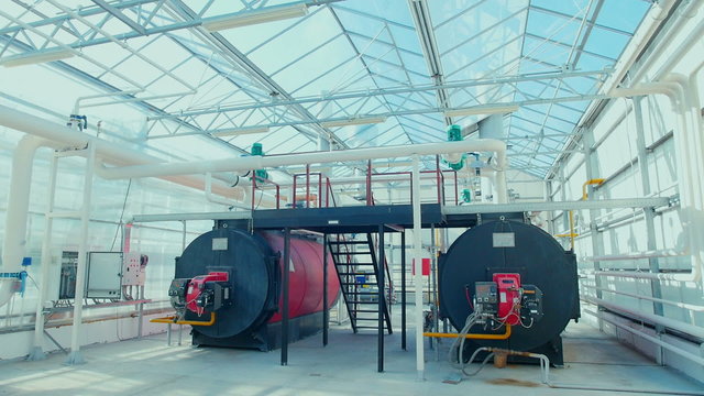 Modern boiler room equipment for heating system. Pipelines, water pump, valves, manometers.