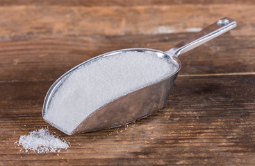 Crystal white sugar in a metal shovel