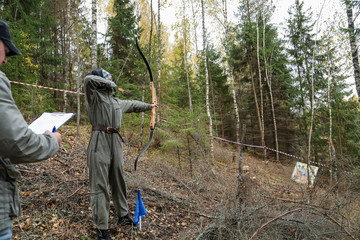 female archer aiming at a target outdoors