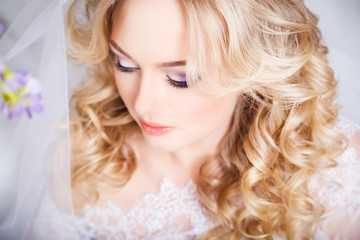 photo of a beautiful blonde bride in a luxurious wedding dress in elegant expensive interior