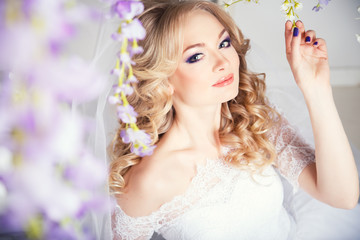 Fototapeta premium photo of a beautiful blonde bride in a luxurious wedding dress in elegant expensive interior