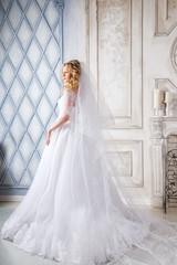 Obraz premium photo of a beautiful blonde bride in a luxurious wedding dress in elegant expensive interior