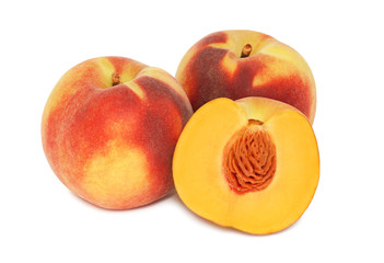Two whole and a half ripe peaches without leaves (isolated)