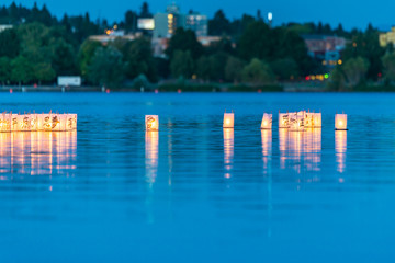Fototapeta na wymiar lantern floating on green lake park for memorial of Hiroshima,Wa,usa.