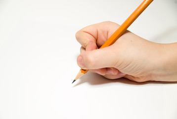 Kid's right hand holding a pencil on over white