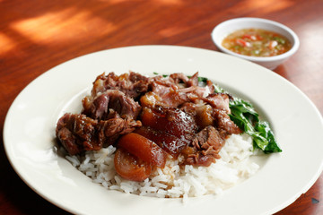 Stewed pork leg on rice with spicy sour sauce