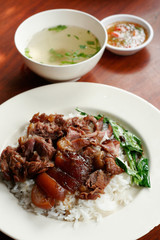 Stewed pork leg on rice with spicy sour sauce and soup