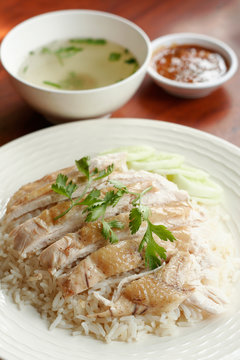 Steamed chicken with rice, soup, and spicy sauce