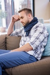 Worried man thinking on the couch 