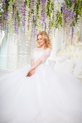 photo of a beautiful blonde bride in a luxurious wedding dress in elegant expensive interior