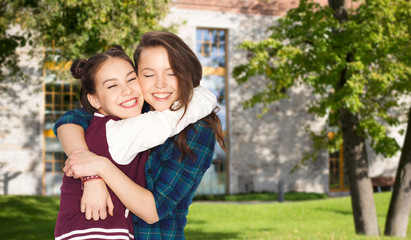 Fototapeta premium happy smiling pretty teenage student girls hugging