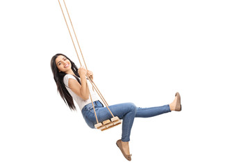 Young carefree girl swinging on a swing