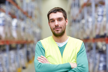 happy man in reflective safety vest at warehouse