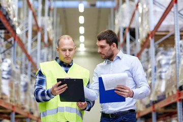 worker and businessmen with clipboard at warehouse