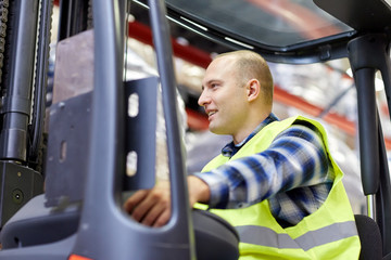 Naklejka premium man operating forklift loader at warehouse