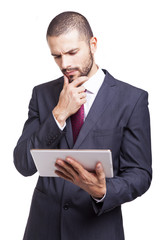 Businessman looking worried to his digital tablet, isolated on w
