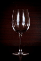 Empty wine glass isolated on wood background