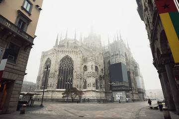 View of the Milan Cathedral with fog that covers the pinnacles o