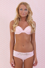 blonde woman dressed in pink lingerie