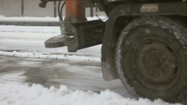 Front shot of plower cleaning up snow